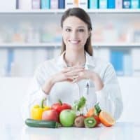 Smiling dietician with healthy vegetables